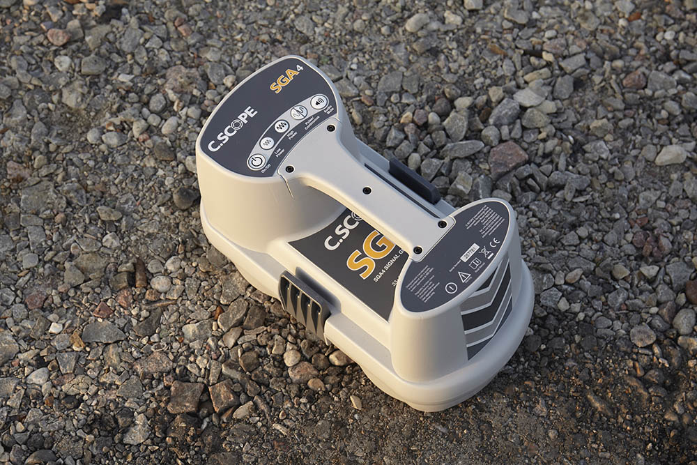 A small electronic device is sitting on the ground.