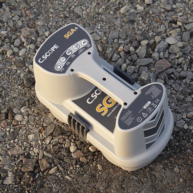 A small electronic device is sitting on the ground.